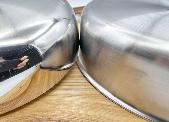 Close up of polished stainless steel cookware surface resistant to rust and corrosion Close up of polished stainless steel cookware surface resistant to rust and corrosion