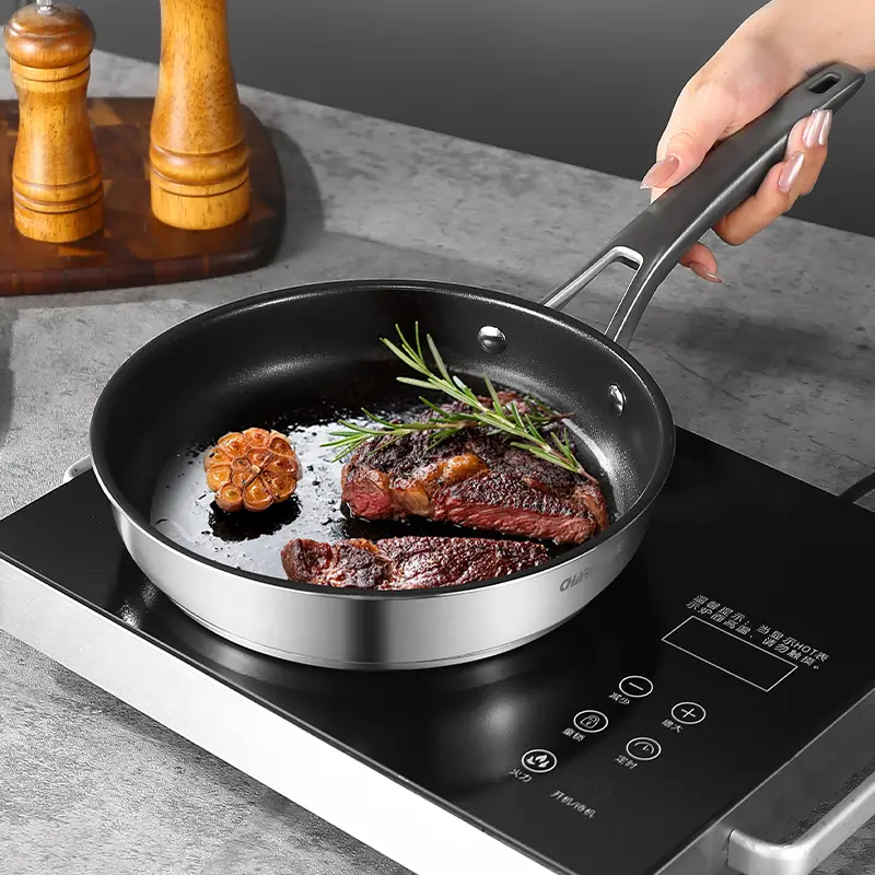 Three stainless steel frying pans arranged on a clean white background, showcasing their sleek design and polished finish.