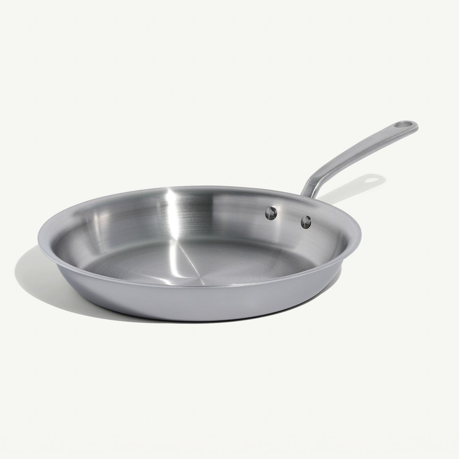 Stainless steel frying pan interior cooking surface and exterior body