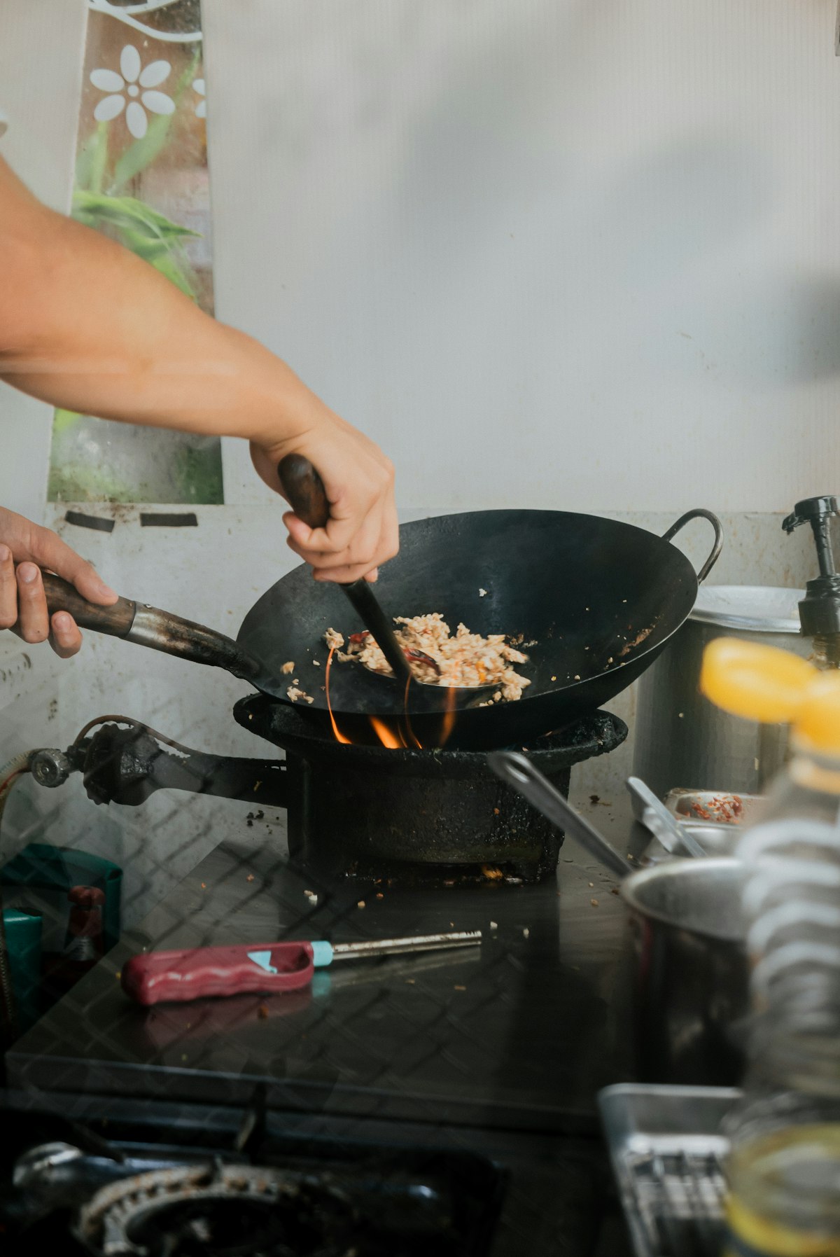 well-seasoned carbon steel wok with dark black patina surface - showing mature non-stick coating after months of use