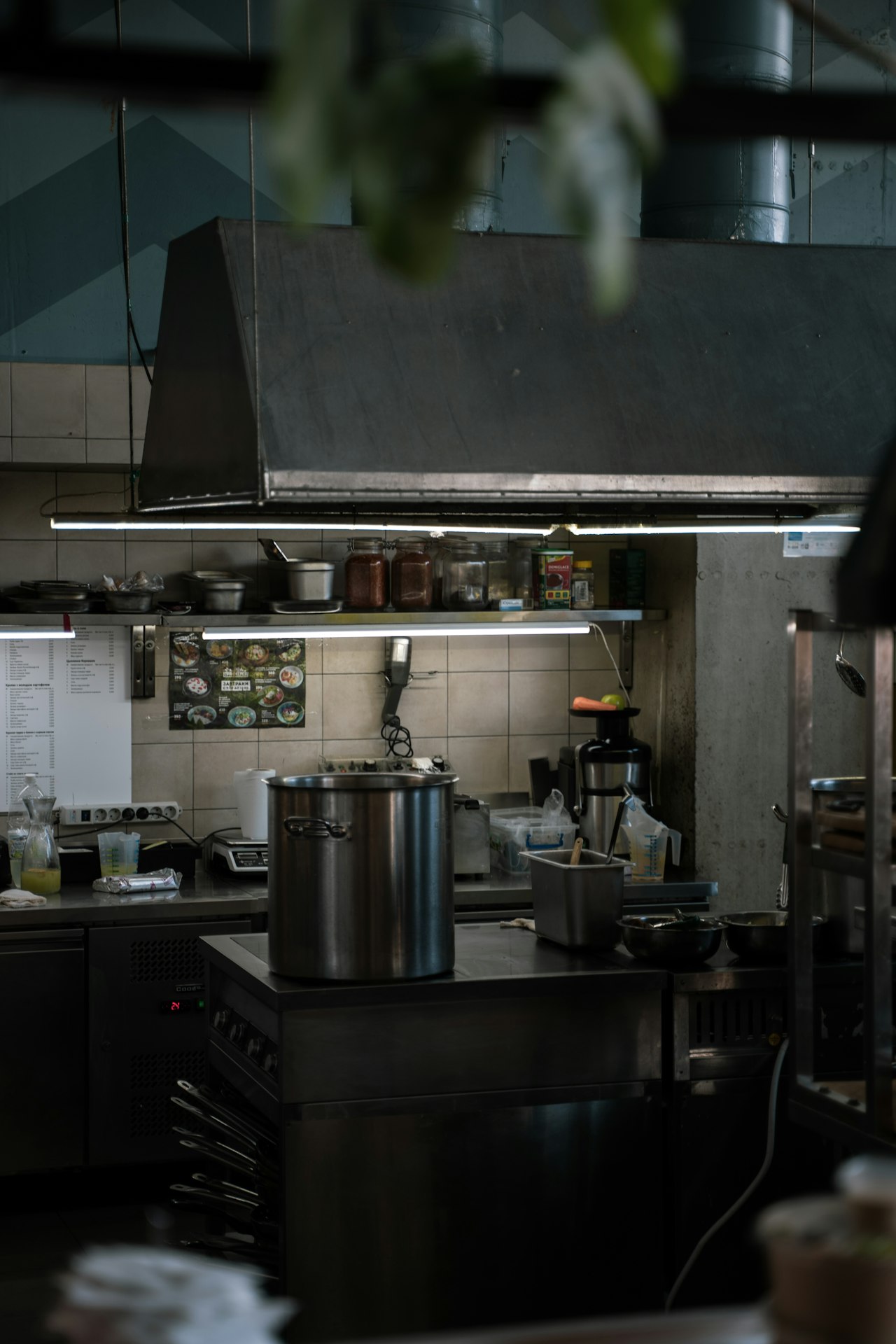 Industrial stainless steel cookware production line — stainless steel cooking pot on stove in commercial kitchen restaurant setting