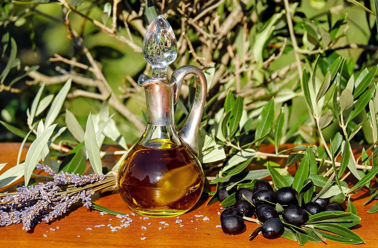 Various cooking oils including avocado, olive and grapeseed oil bottles on a kitchen counter - best oils for stainless steel cookware