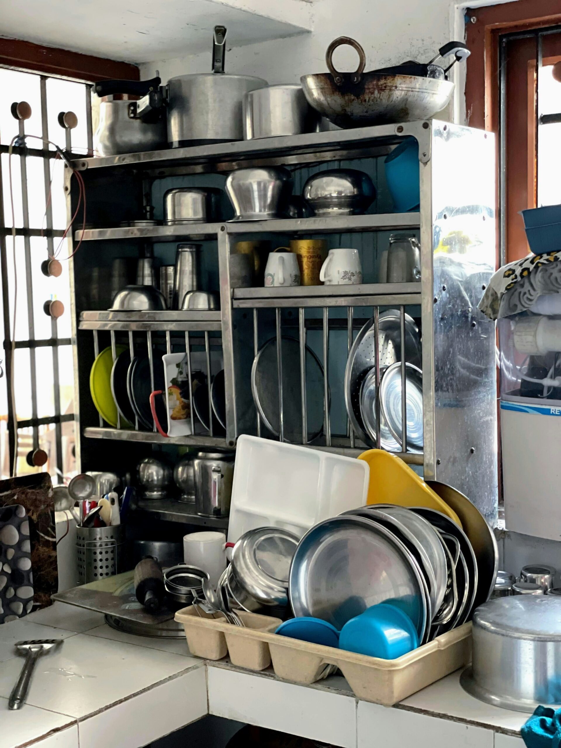Organized kitchen cabinet with pots and pans neatly stored - showing proper cookware storage setup