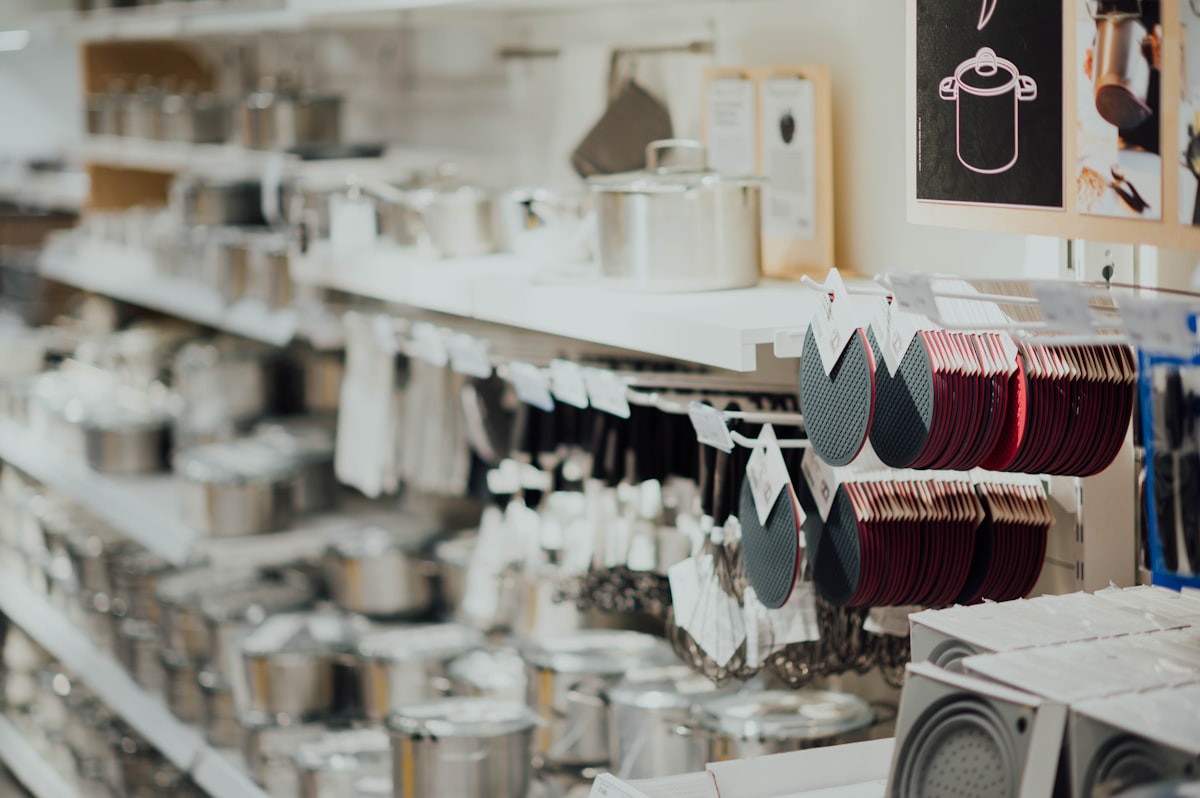 Stainless steel cookware display showing multi-ply construction and polished surface — chromium oxide passive layer protection