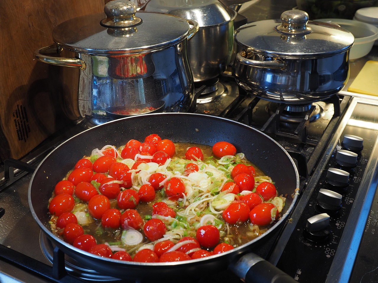Stainless steel cookware set in a modern kitchen - pots and pans suitable for recycling at end of life