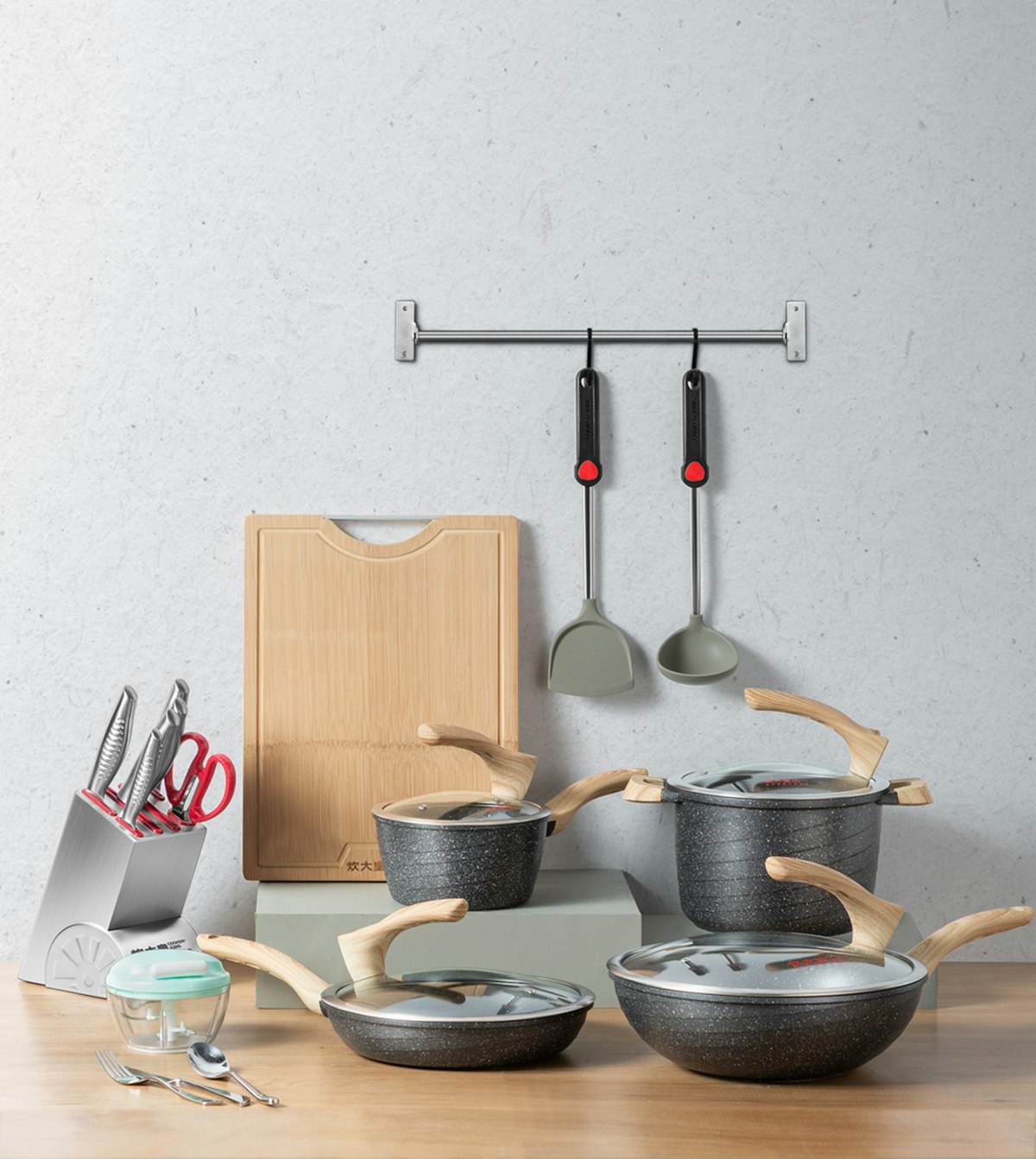 Stainless steel cookware sets arranged for wholesale export from a Chinese manufacturer - multiple pots and pans with lids ready for B2B bulk shipping