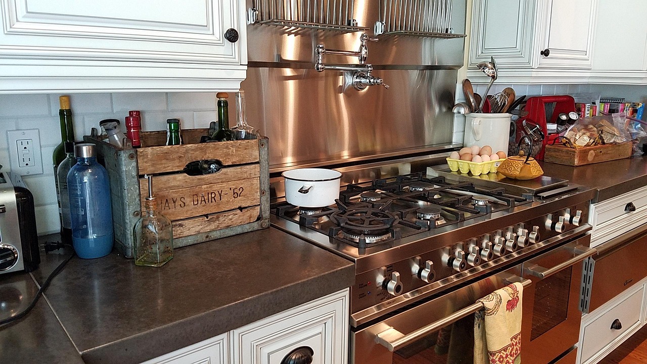 Stainless steel pan on gas stovetop with high heat flame - showing direct burner contact during high-heat searing