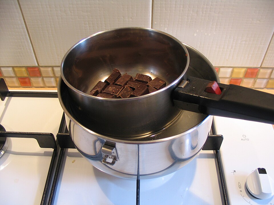 Stainless steel bain marie double boiler with GN food pans in a commercial buffet setting - indirect water bath heating method