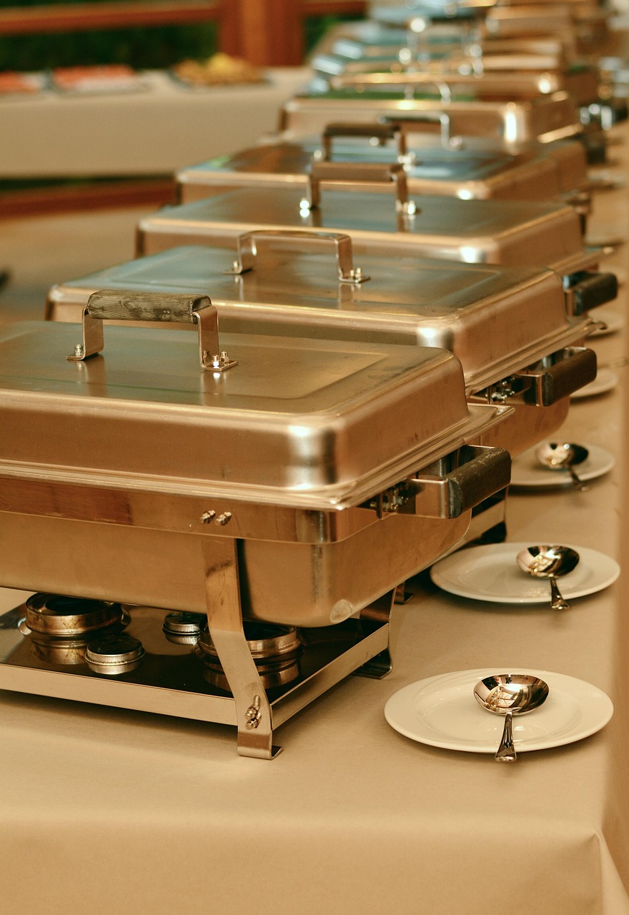 Stainless steel chafing dishes in commercial food service buffet setup - wholesale food containers for restaurants and catering